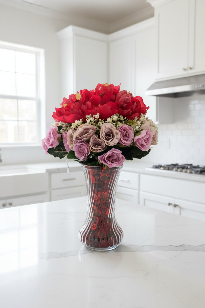 Red/Purple Passion Silk Floral Arrangement with baby's breath in glass-swirl vase filled with red translucent gems.