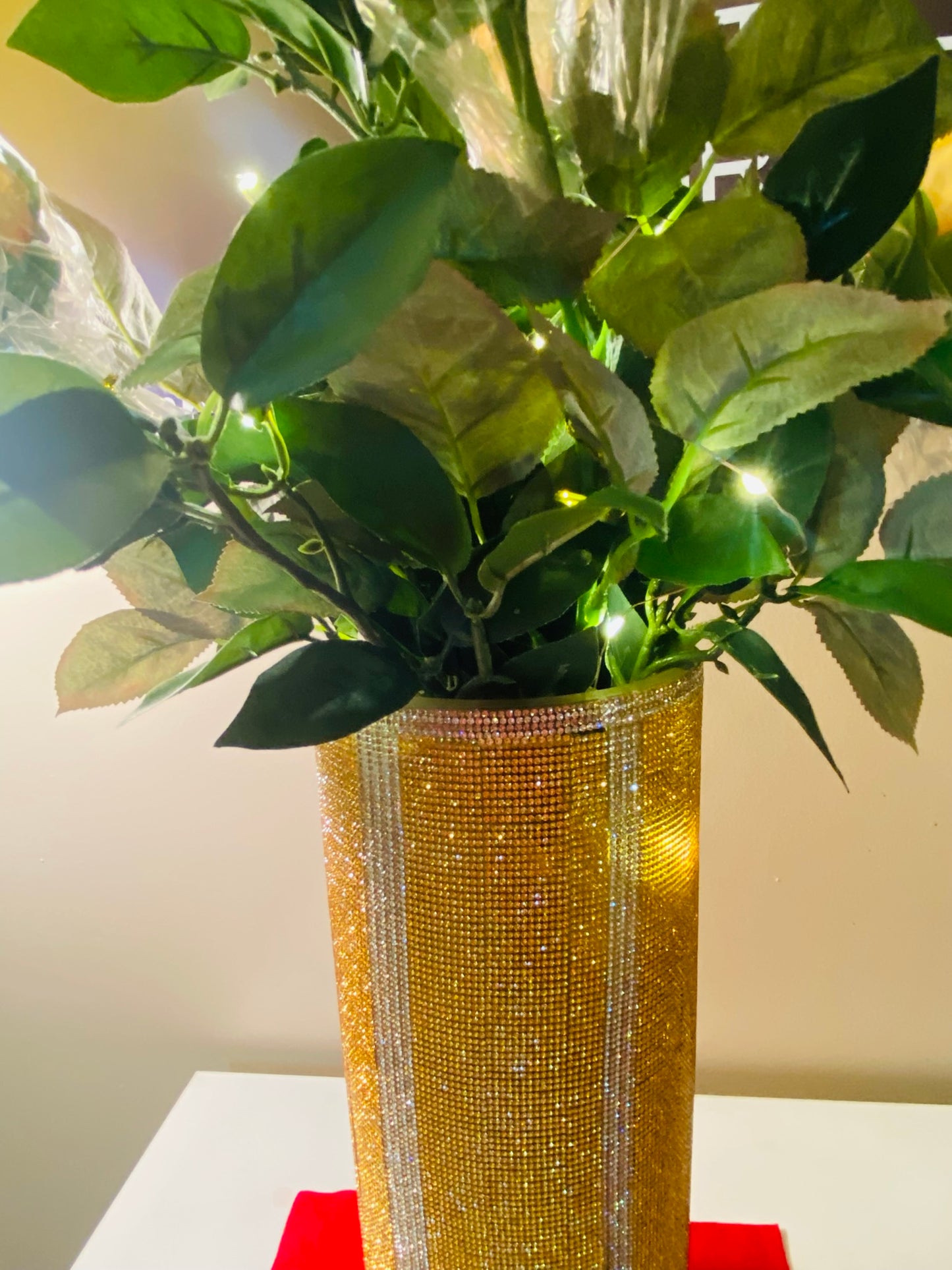 Vibrant Gold V-Style Crystal Rhinestone Cylinder Vase is 15" tall. Long-stem silk floral arrangement sold separately.