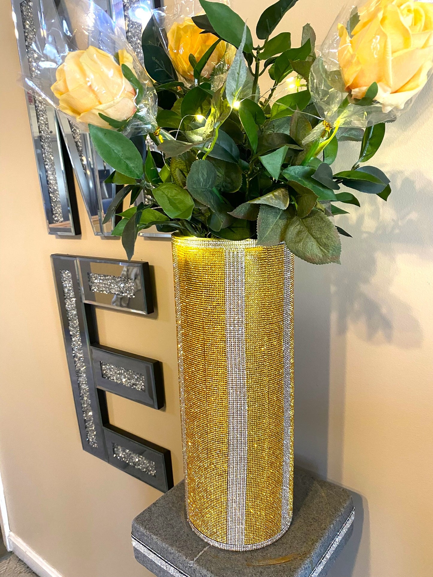 Vibrant Gold V-Style Crystal Rhinestone Cylinder Vase is 15" tall. Long-stem silk floral arrangement sold separately.