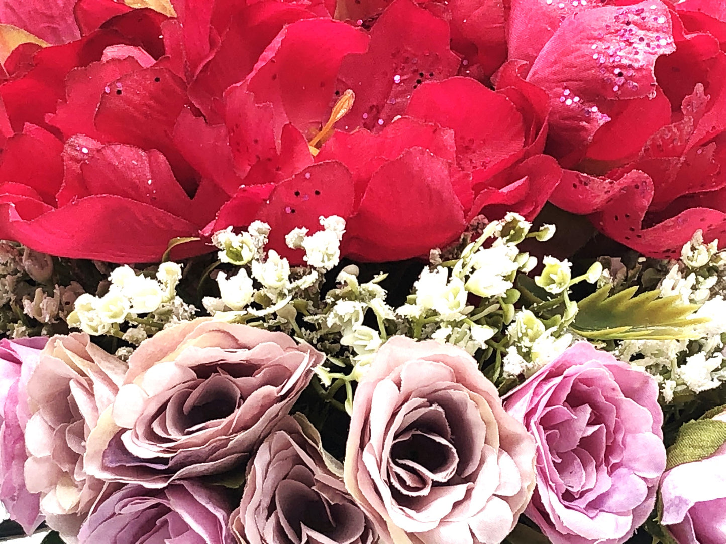 Red/Purple Passion Silk Floral Arrangement with baby's breath in glass-swirl vase filled with red translucent gems.