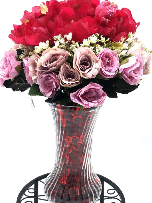 Red/Purple Passion Silk Floral Arrangement with baby's breath in glass-swirl vase filled with red translucent gems.