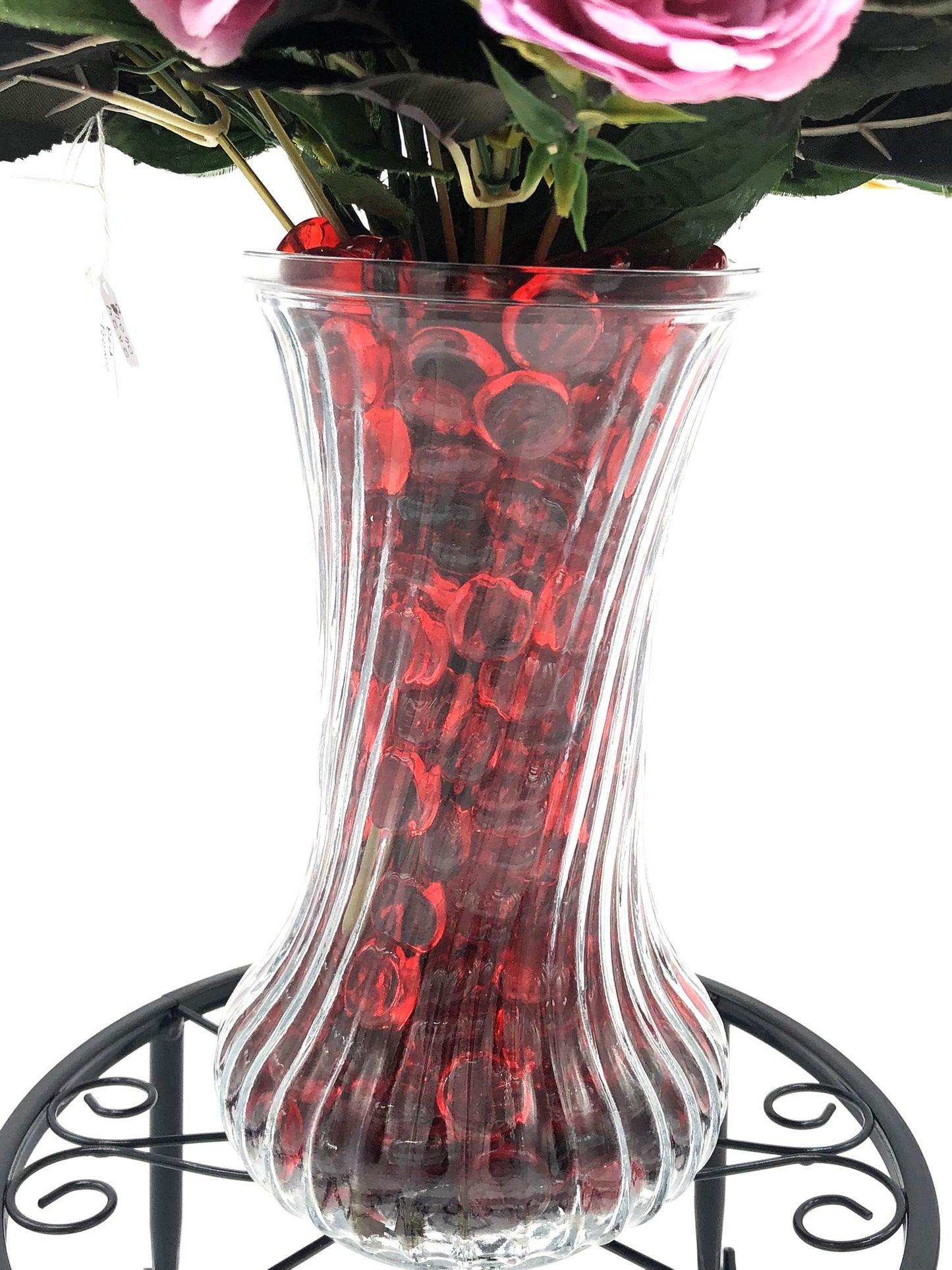 Red/Purple Passion Silk Floral Arrangement with baby's breath in glass-swirl vase filled with red translucent gems.