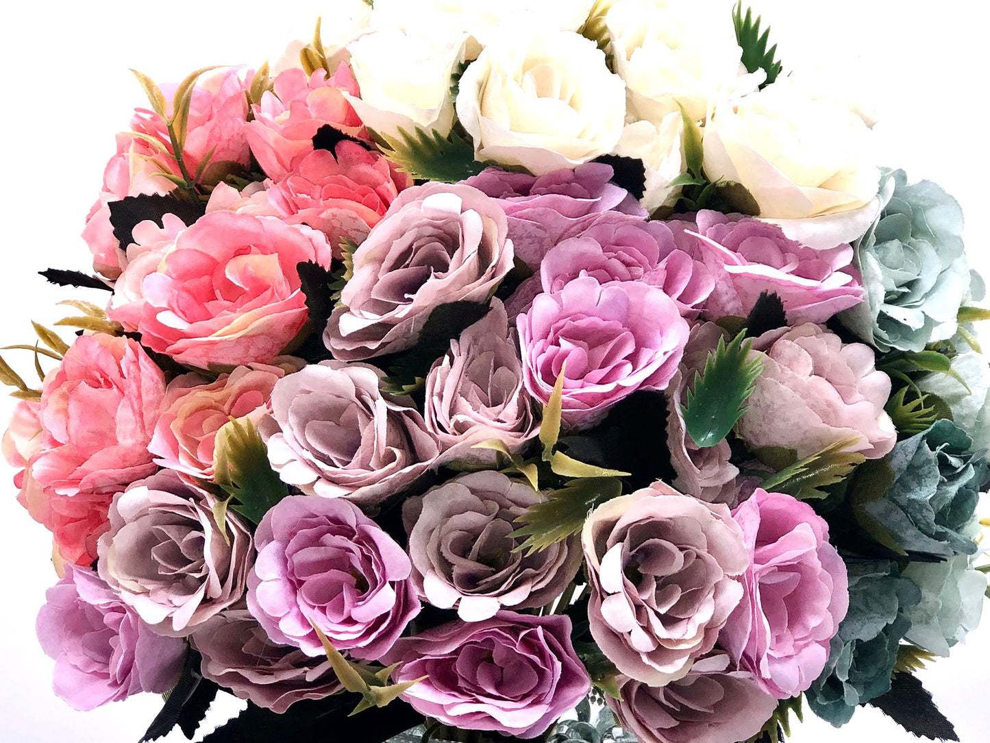 Rose Color Medley in Sculpted-Glass Vase with Crystal Rhinestone trim. Lucious bouquet of small roses with greenery a beautiful silk floral arrangement.